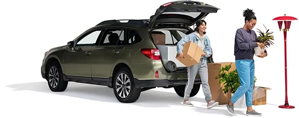 A mother and daughter unload home furnishings from their SUV.